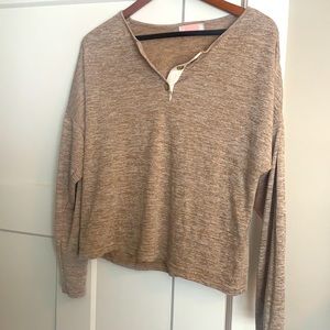 Oatmeal colored Henley.  Cropped length.  Hits at hip.